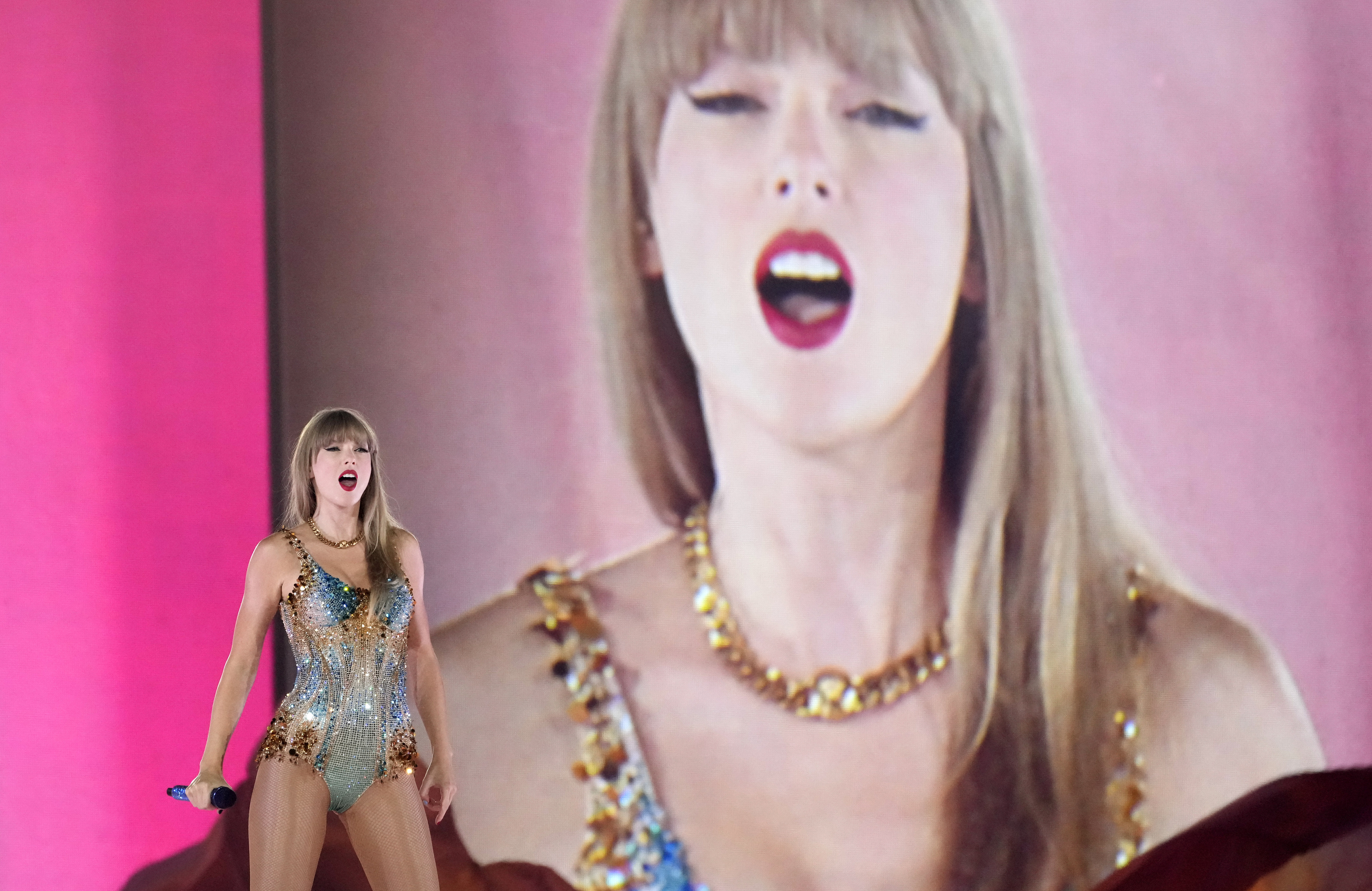 Taylor Swift performs with enlarged version of her face behind her during 'Eras Tour' concert at SoFi Stadium, Aug. 7, 2023