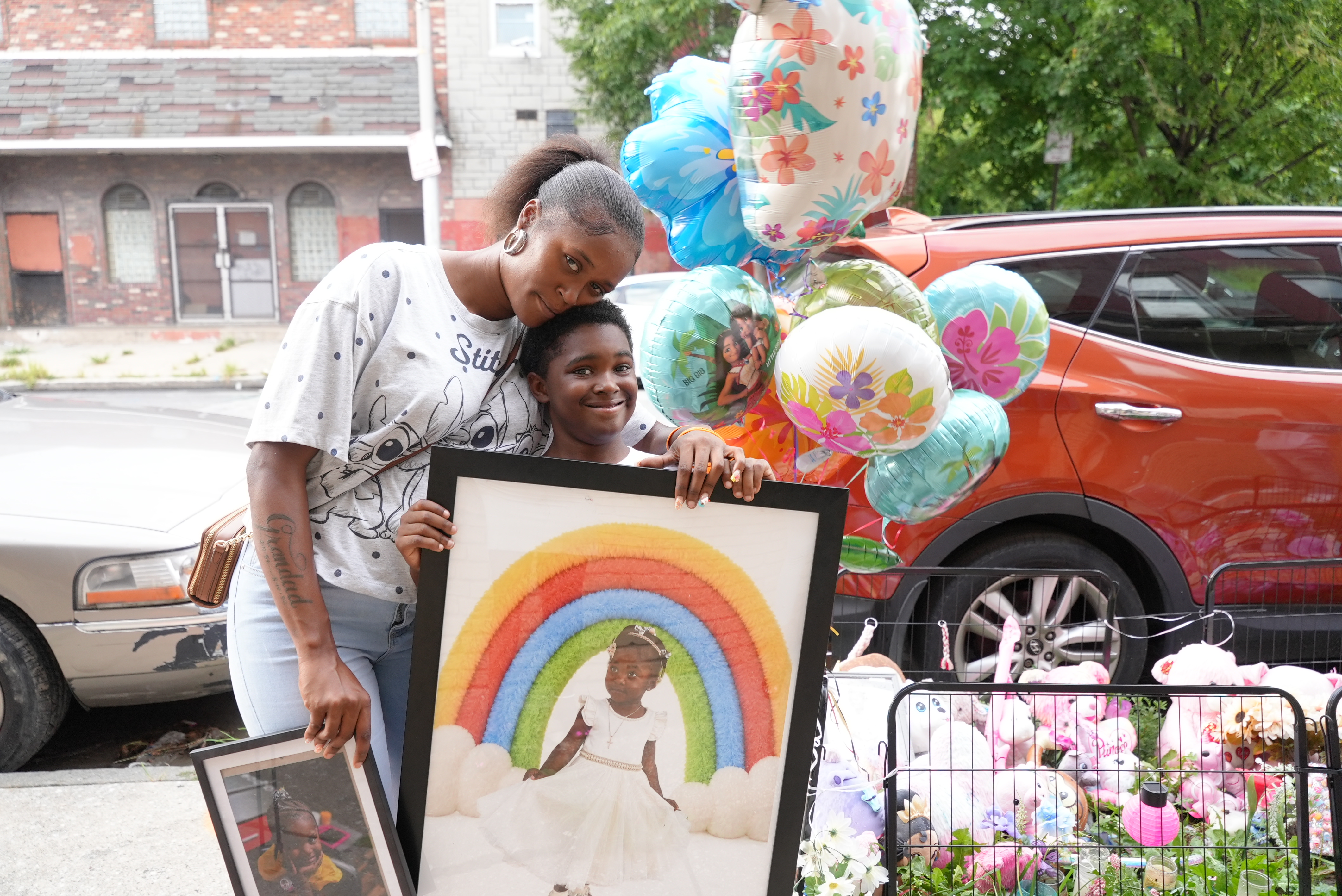 Nyjada Billy and her son in front of Jordan's memorial