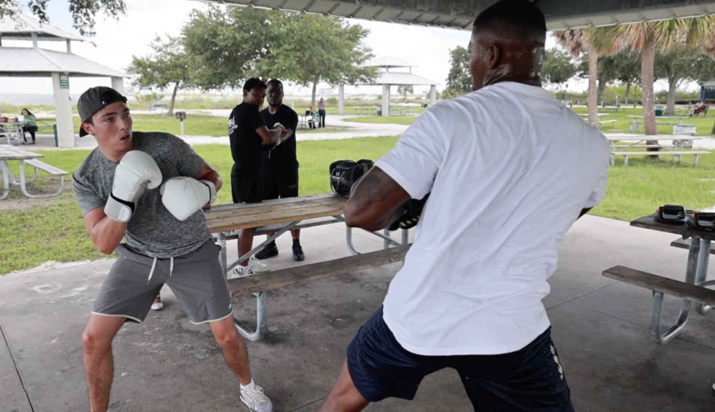 Jacusto Colon (right) boxing with trainee Mason Moreno (left).