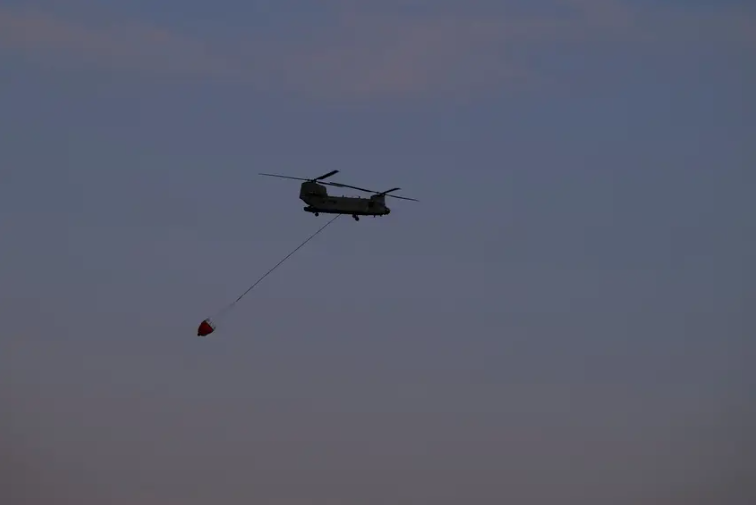 A Chinook helicopter responds to the Roughneck fire near Sanford on March. 3, 2024. Several wildfires have devastated the Panhandle in recent weeks.