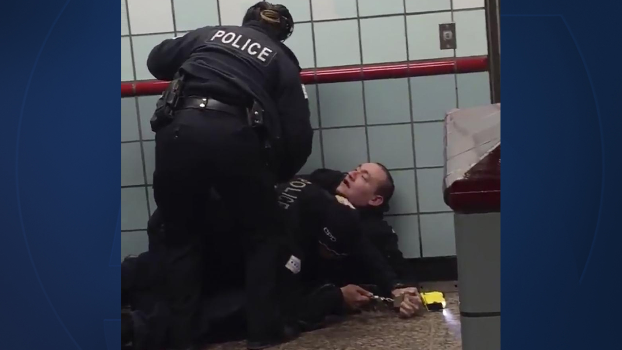 This Friday, Feb. 28, 2020 image from cellphone video shows Chicago police officers trying to apprehend a suspect inside a downtown Chicago train station. After a struggle with police, the suspect was shot as he fled up the escalator with the officers in pursuit. 