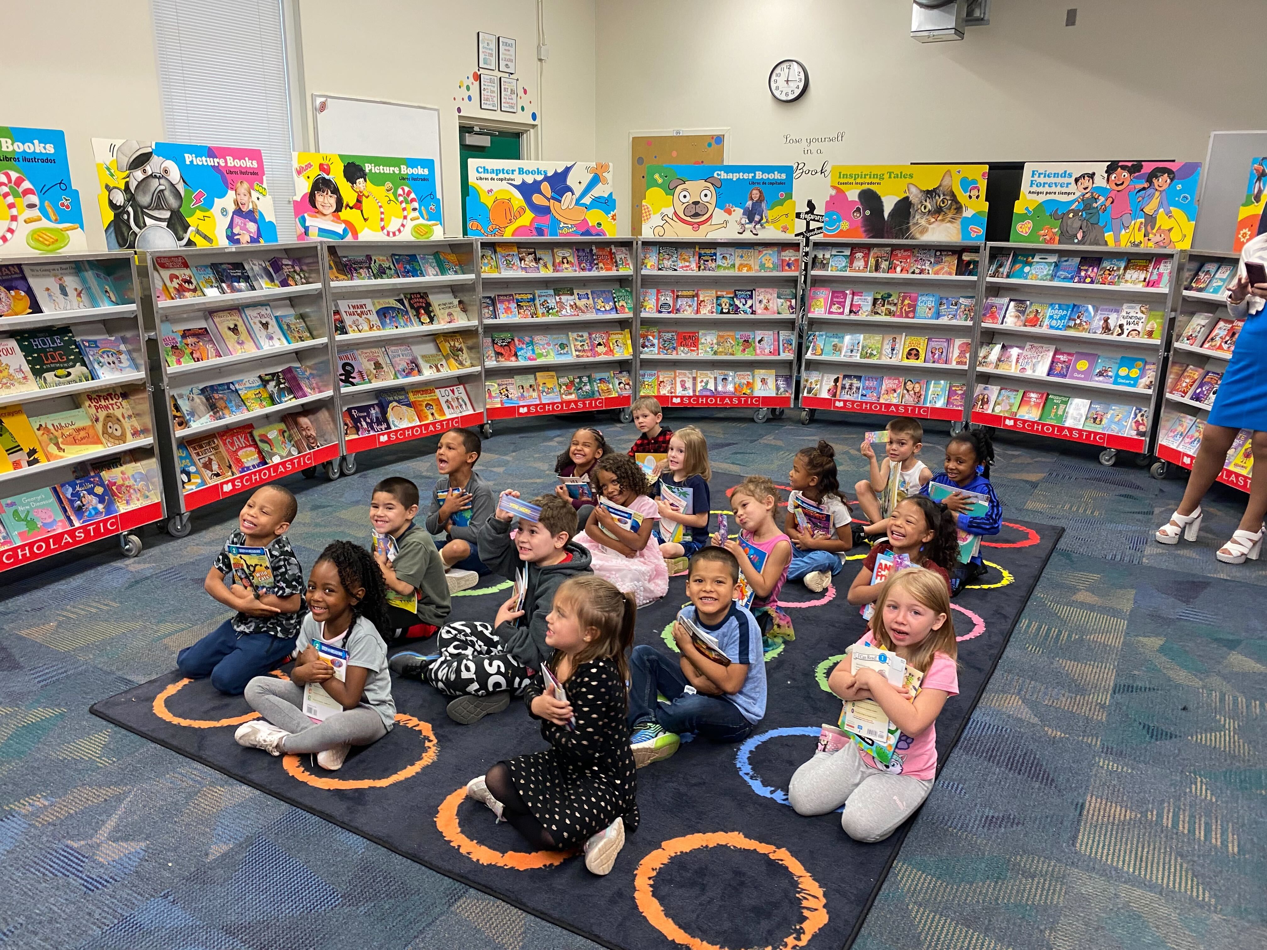Students at Queen Palmer receiving four free books