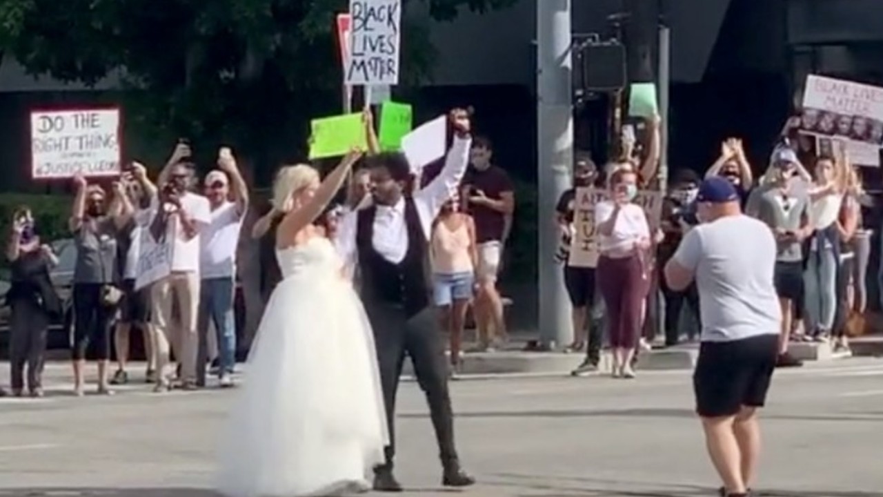 Bi-racial couple cheered on as they visit Black Lives Matter protest after wedding