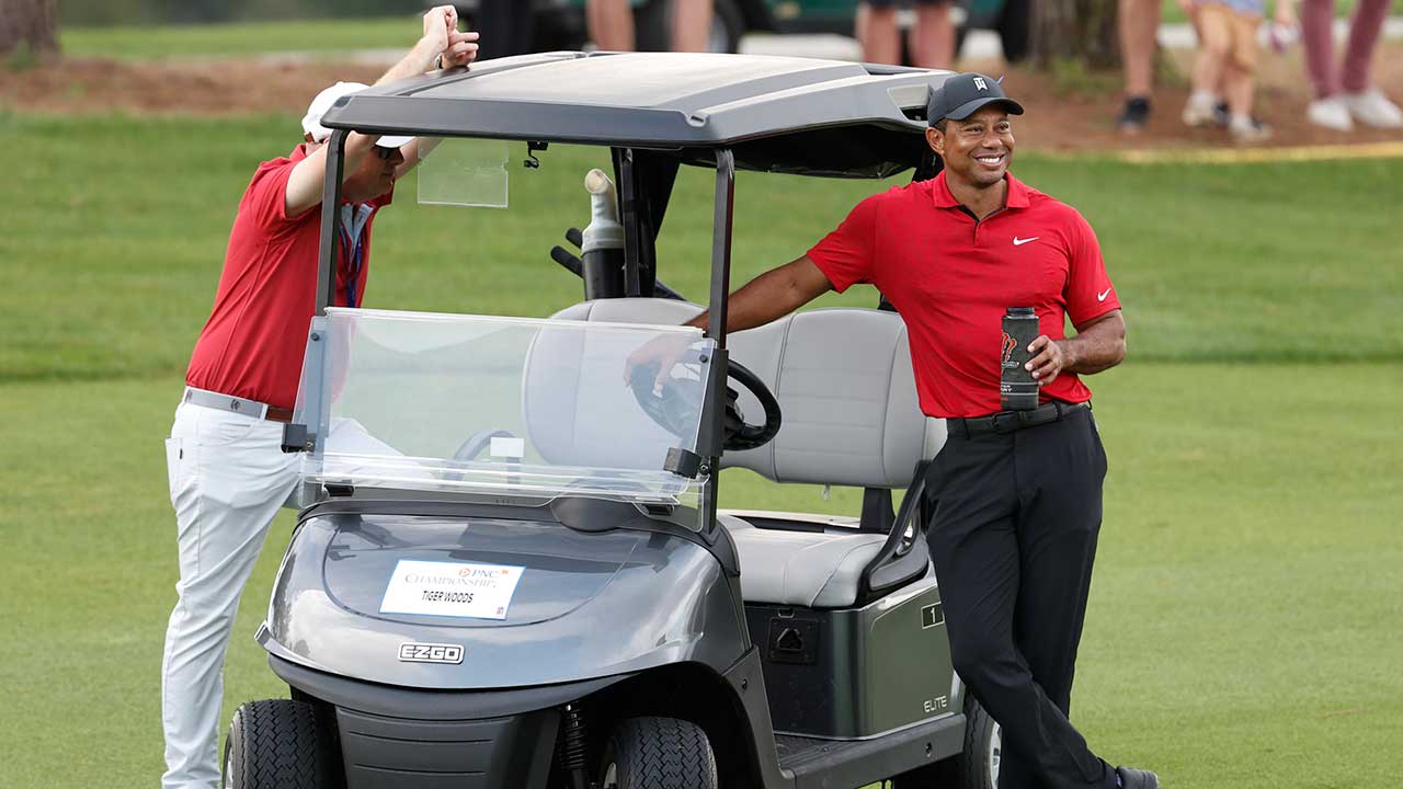 Tiger Woods stands with his cart on the third fairway during the second round of the PNC Championship golf tournament Sunday, Dec. 19, 2021, in Orlando, Fla. (AP Photo/Scott Audette)