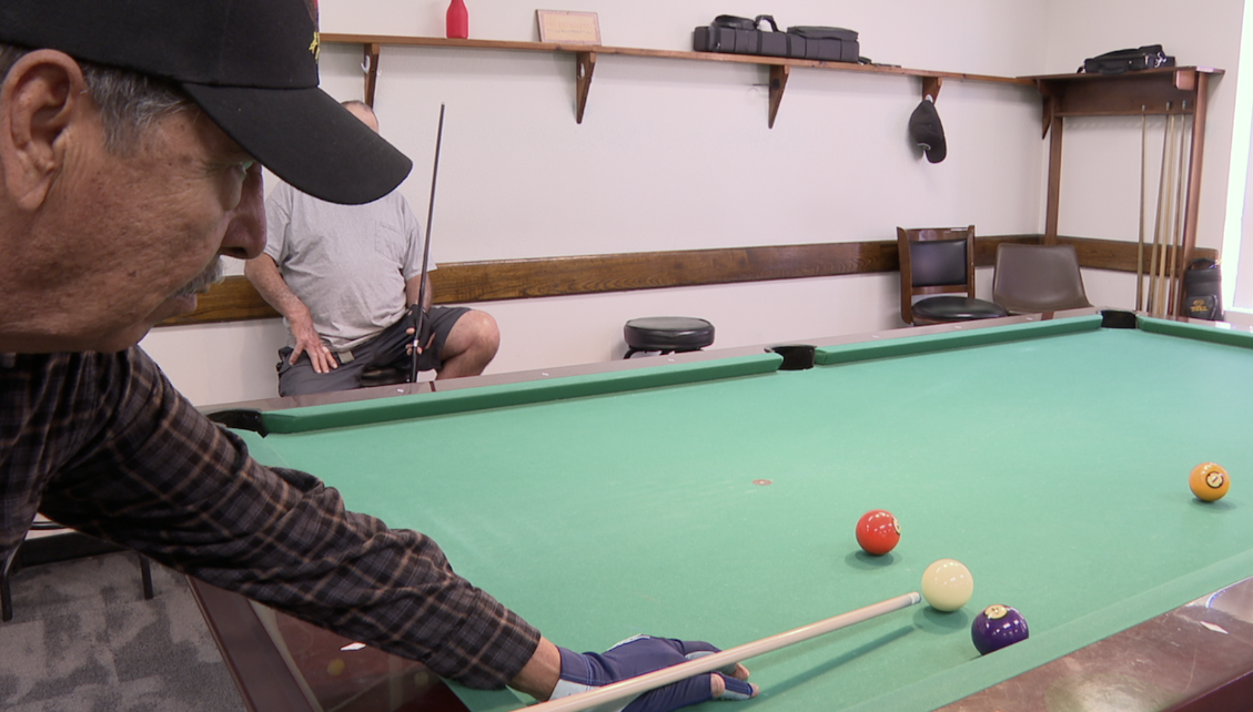 Pedro Ramos is playing some pool at Park Avenue Community Center with his other senior friends. 