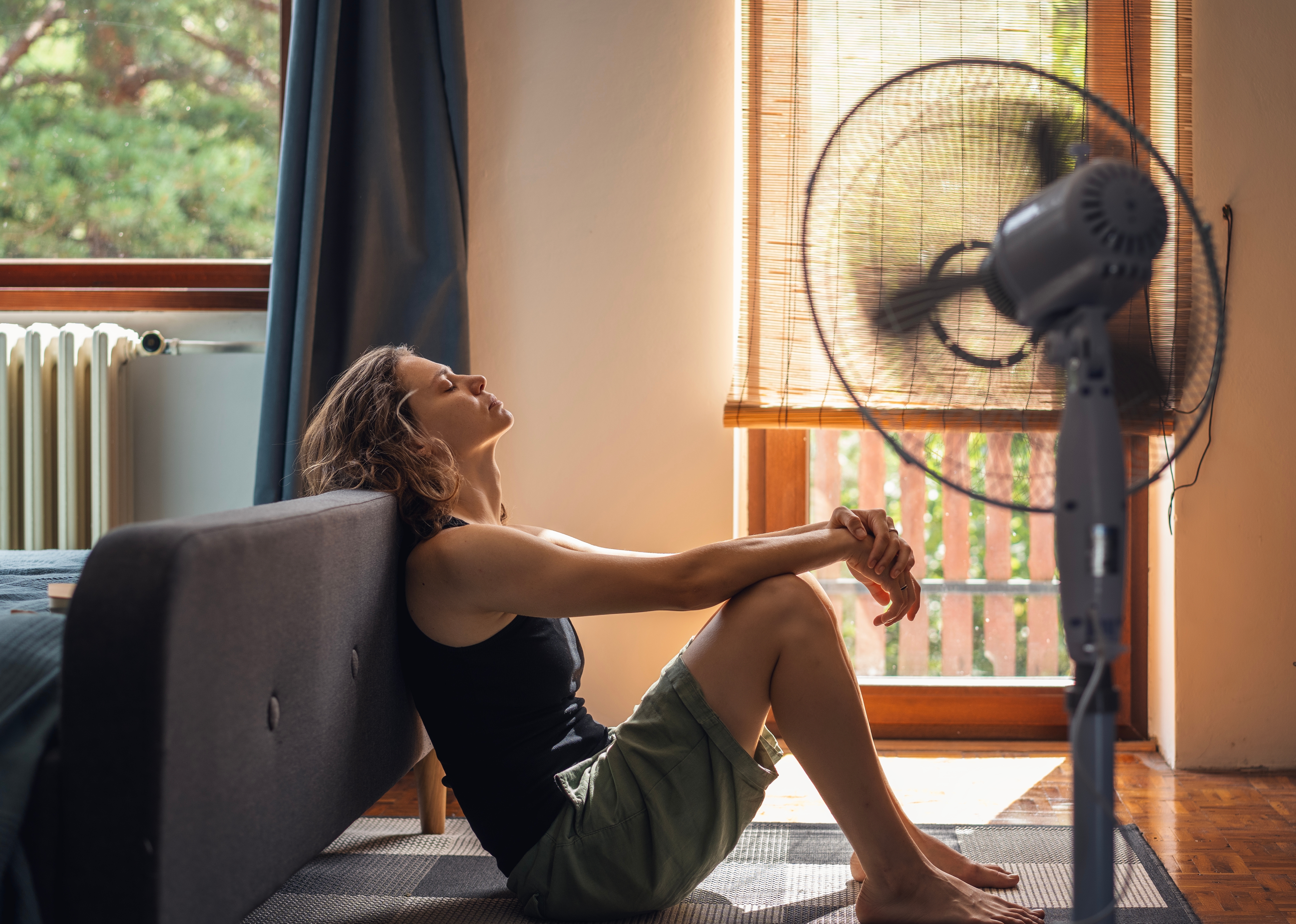 Woman suffering from extreme heat in her home.