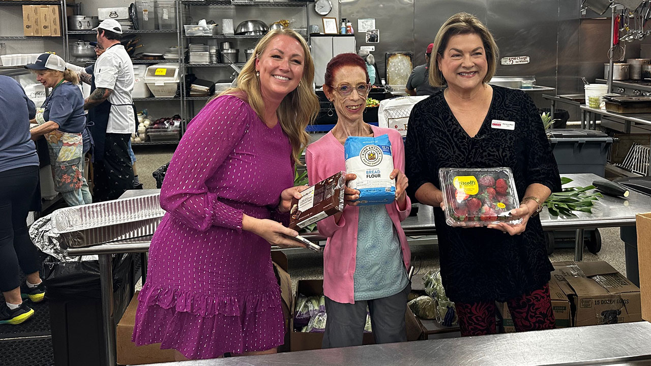 Linda Pincus (center) shows off her new baking ingredients courtesy of the Soup Kitchen in Boynton Beach with CEO Marlene Mejia (right) and WPTV morning anchor Ashley Glass (left).