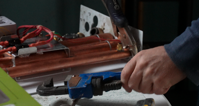 John Hopper working on a broken water heater 