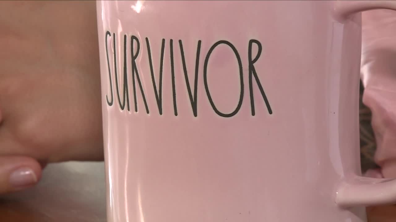 Breast cancer survivor Nicole Smith of Palm Beach County holds a "Survivor" mug.jpg