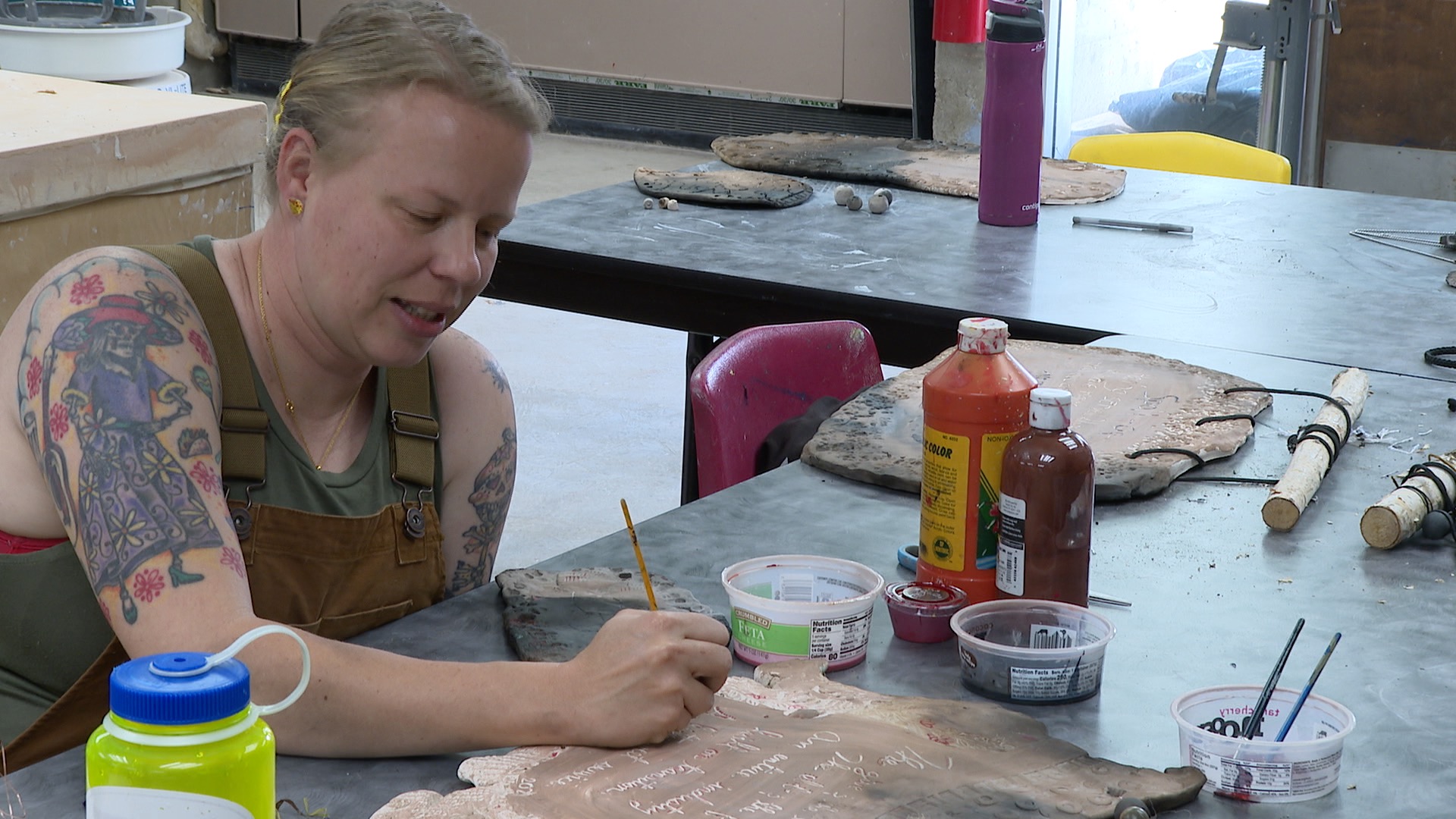 An Army Servicemember works with clay