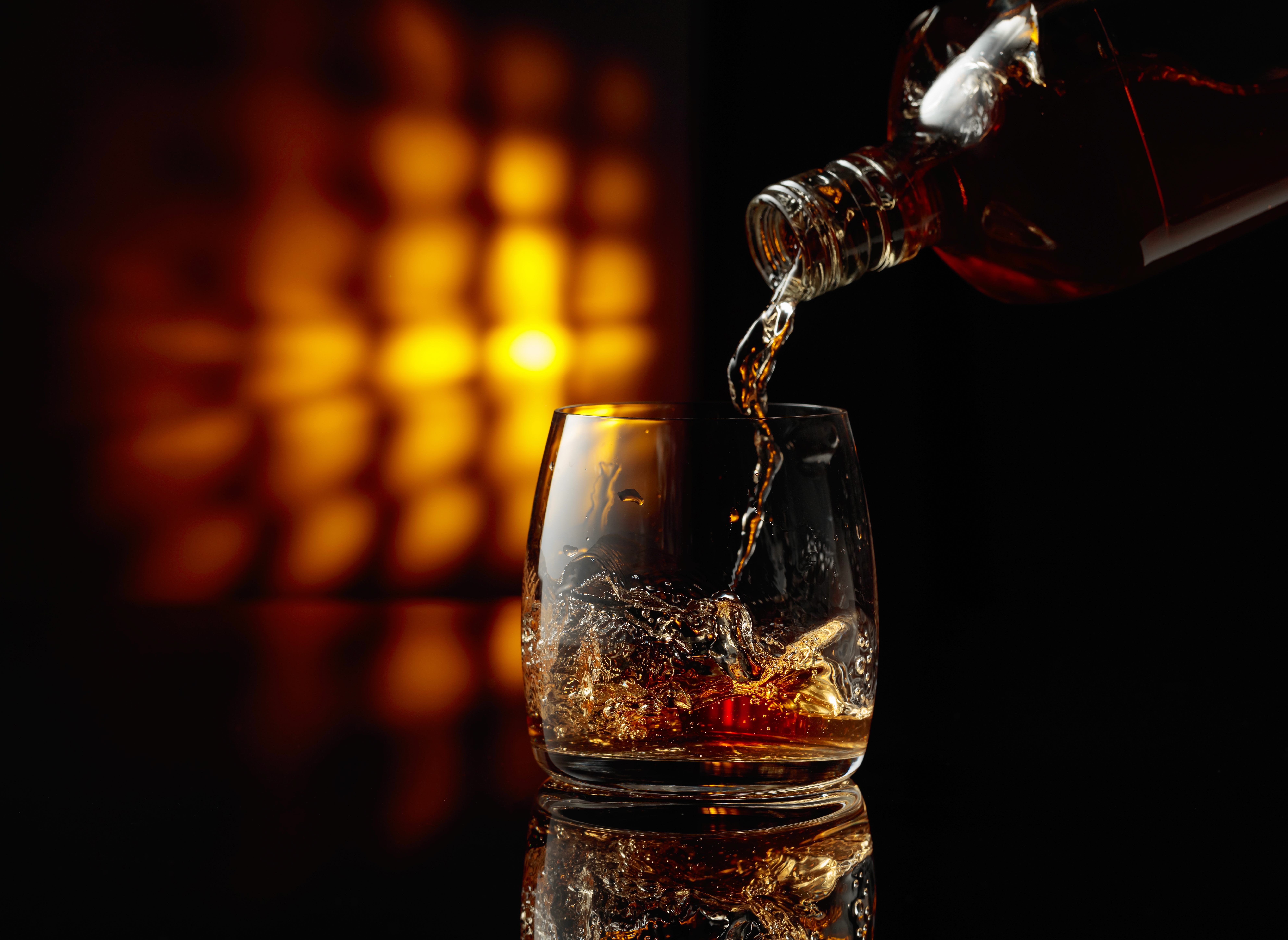 Alcohol being poured into a glass. 