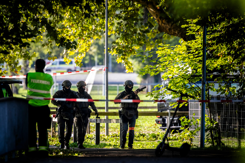 Police officers secure the area around the Schachen horse racing track following a shooting at a rave, in Aarau, Switzerland, Sunday Aug. 30, 2026.