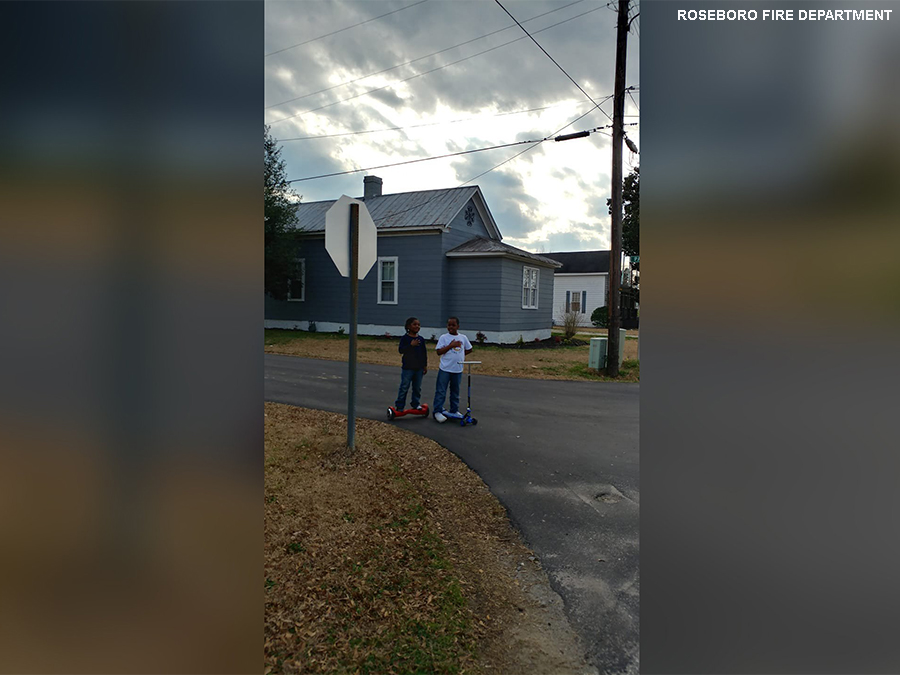 2 boys stopped in the road to recite the Pledge of Allegiance