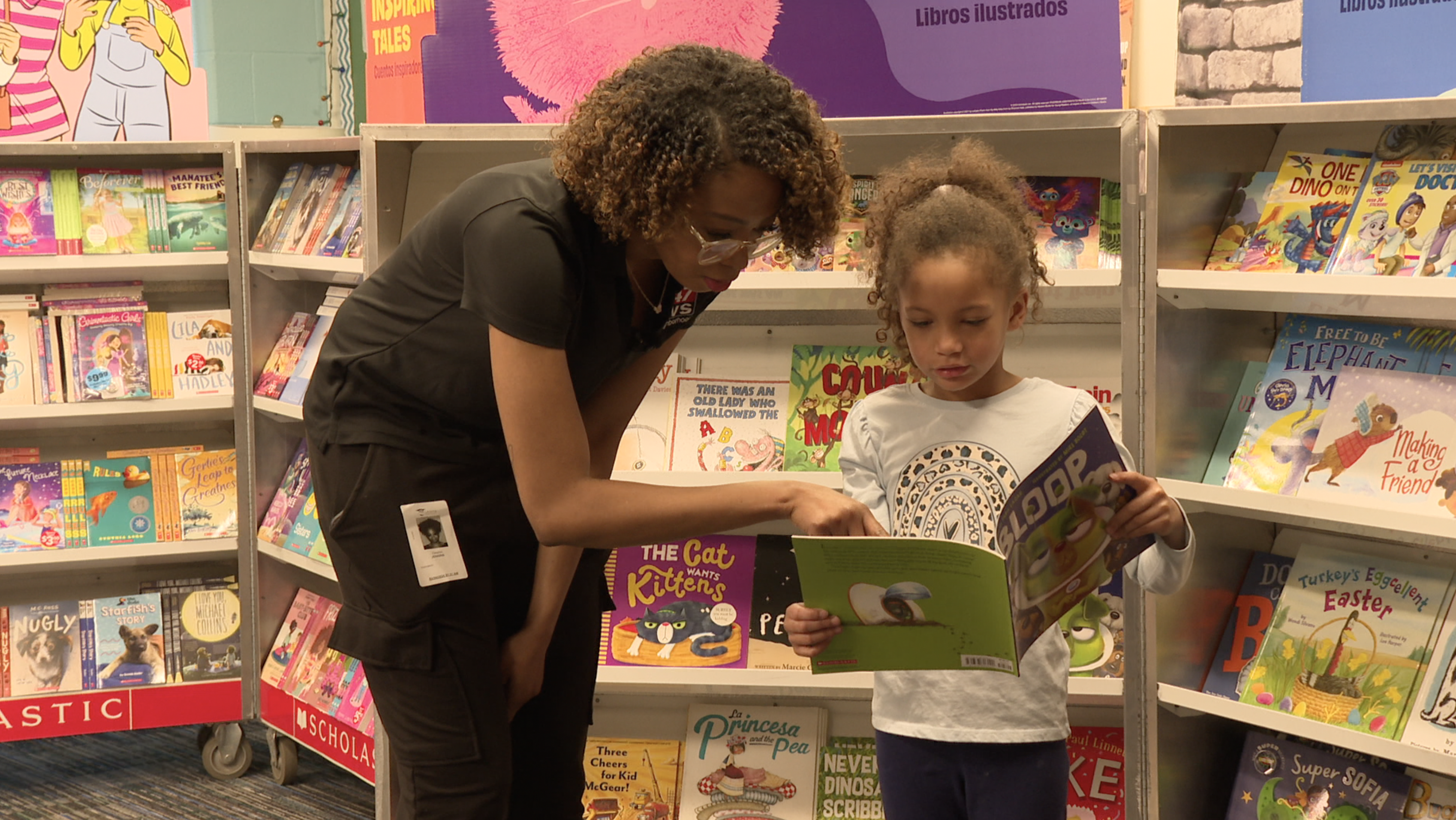 Tianna Jenkins and Rogue reading a book