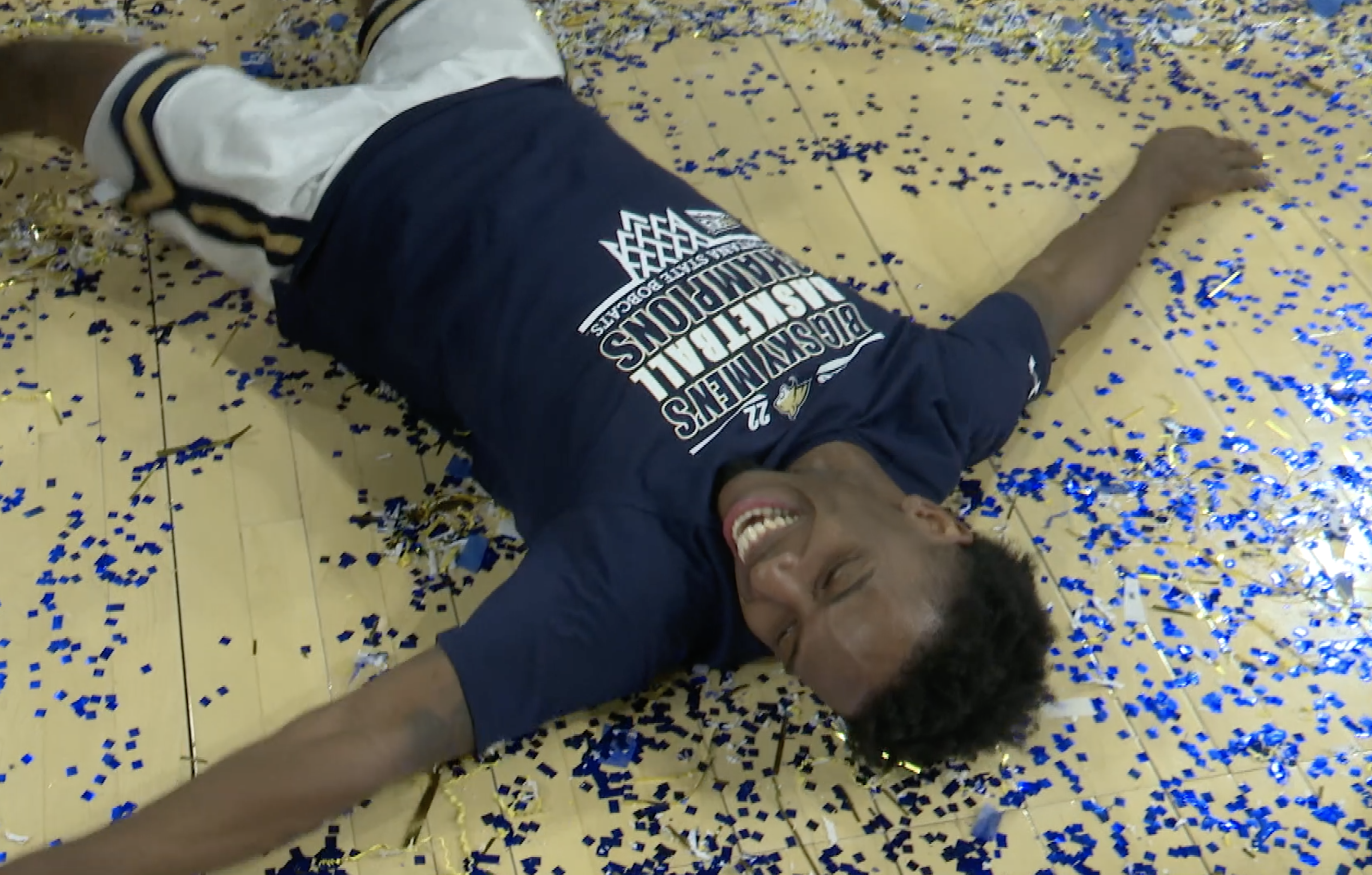 Xavier Bishop celebrates winning the 2022 Big Sky regular-season championship by making confetti angels courtside.