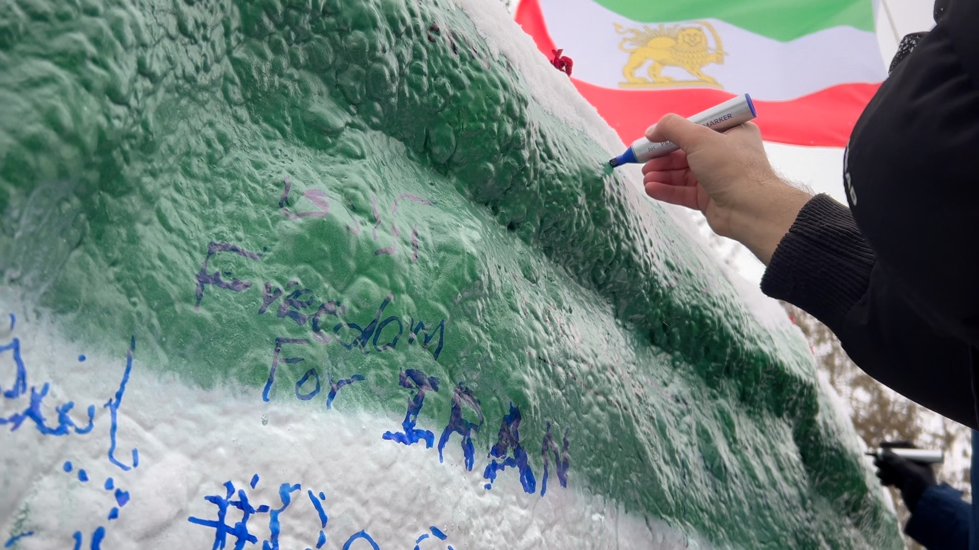 Iranian MSU student writes on The Rock after a demonstration for Iran