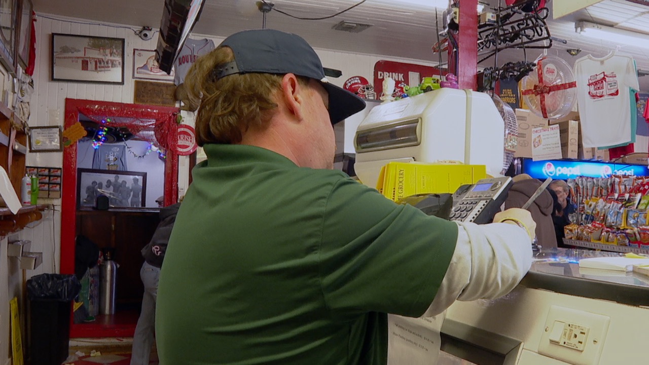 Manager Kyle Maurer writing down orders at Old Tyme Grocery 