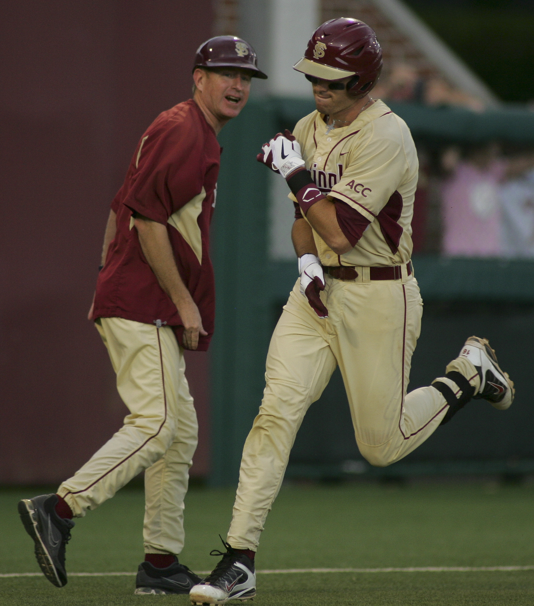 Florida State Seminoles third base coach Mike Martin Jr. congratulates Jayce Boyd in Tallahassee super regional game in 2010