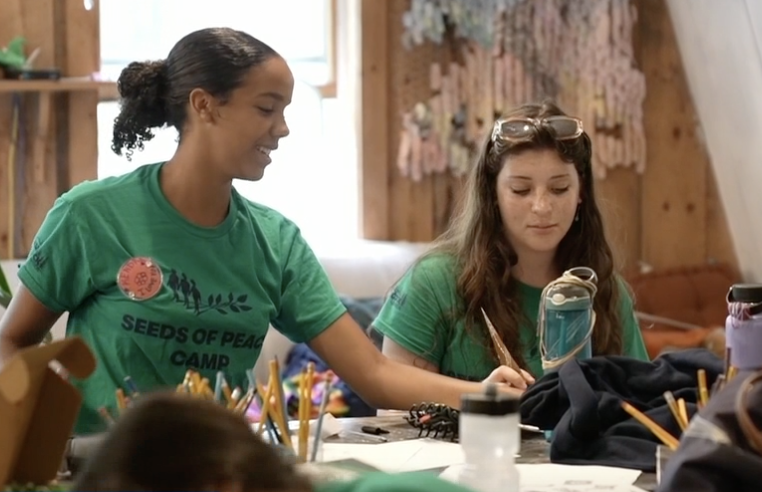 Seeds of Peace Camp members participate in an arts and crafts activity.