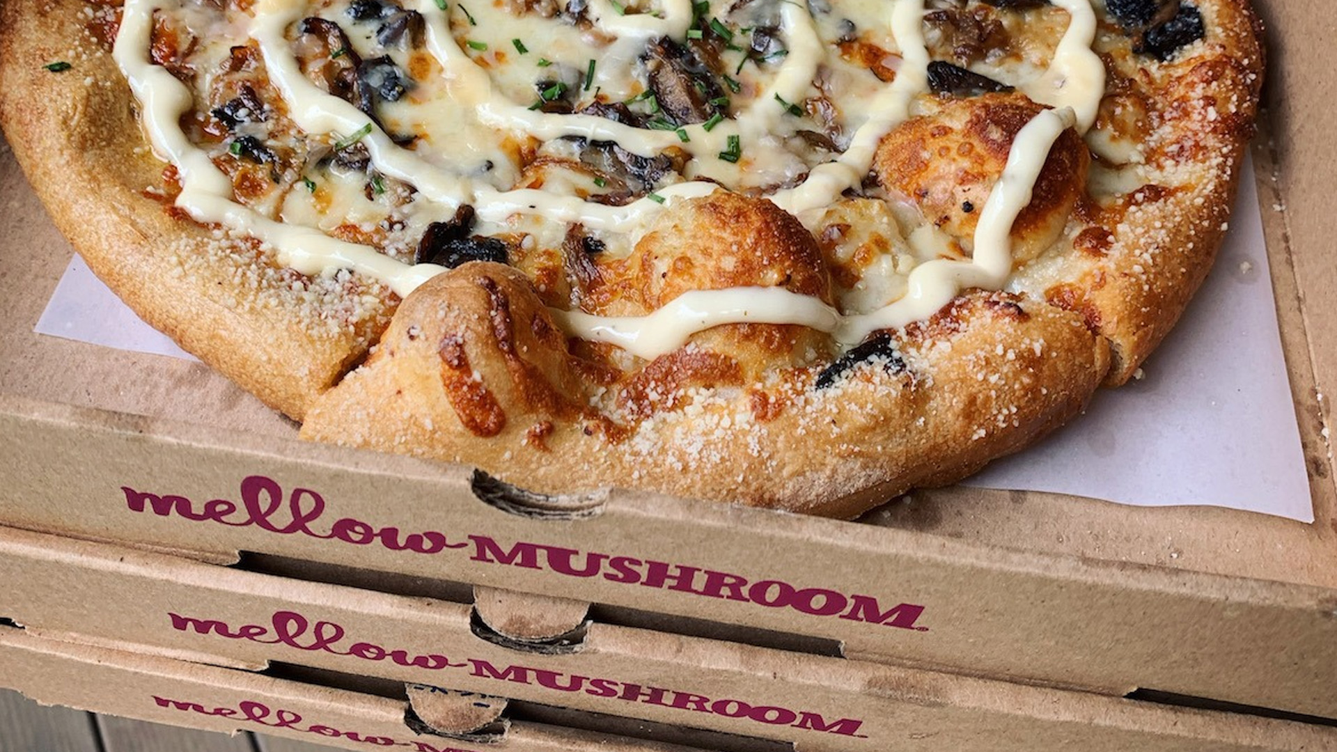 Mellow Mushroom pizza on top of boxes
