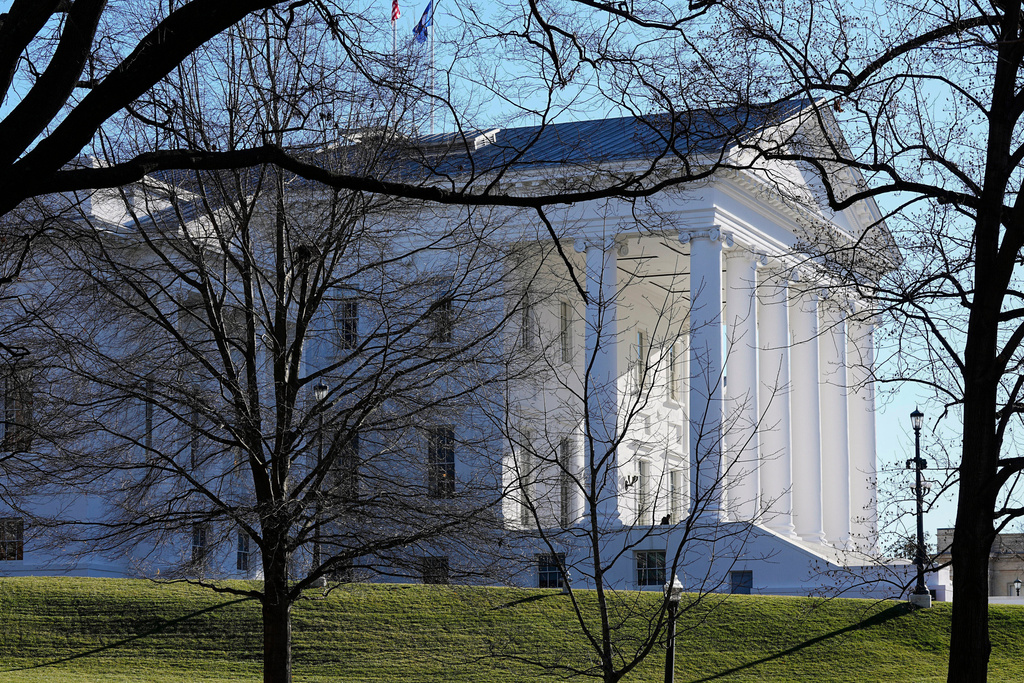 The state and U.S. flags fly over the Virginia State Capitol.