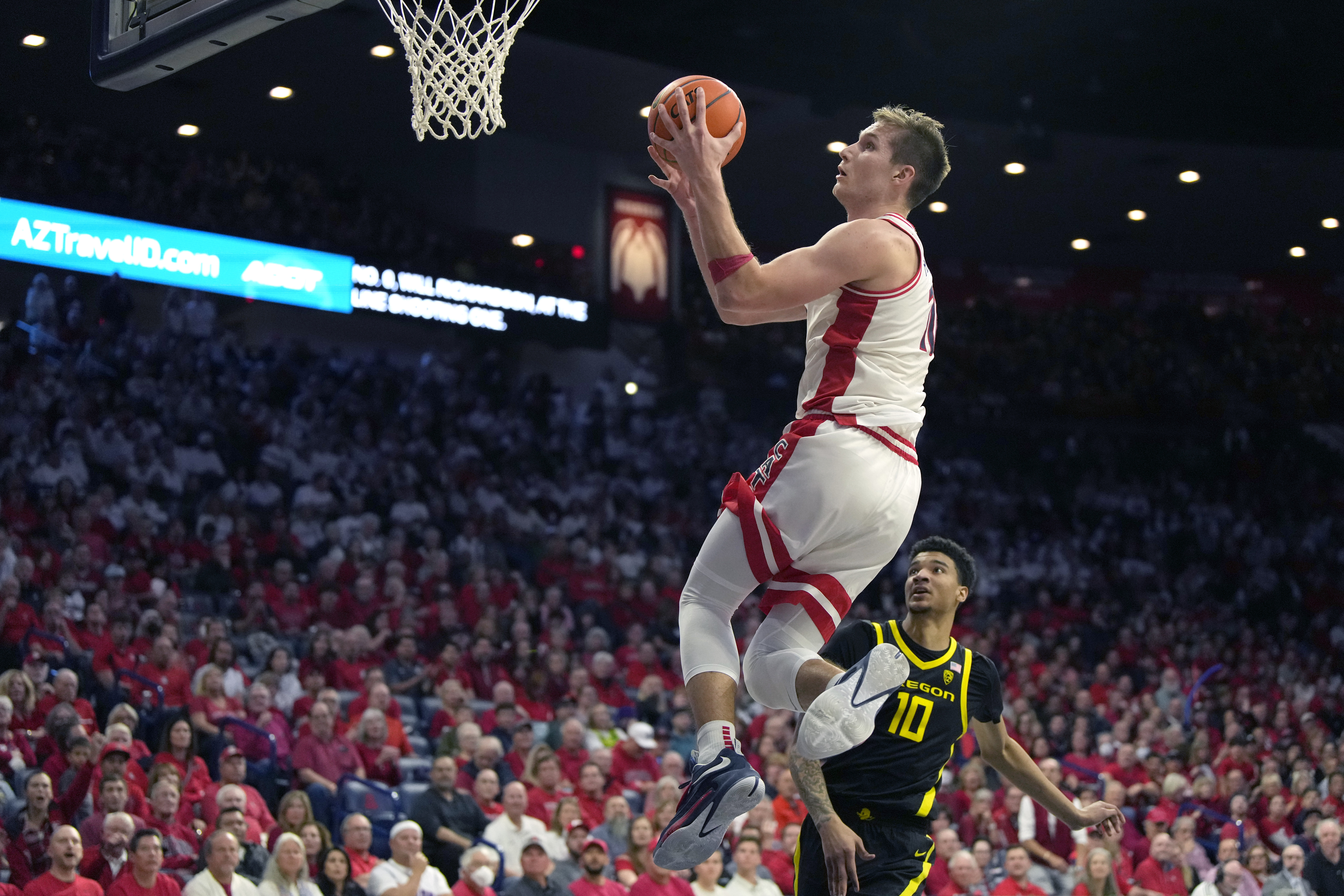 Arizona forward Azuolas Tubelis scores over Oregon center Kel'el Ware (10) during the second half of an NCAA college basketball game, Thursday, Feb. 2, 2023, in Tucson, Ariz. Arizona won 91-76. (AP Photo/Rick Scuteri)