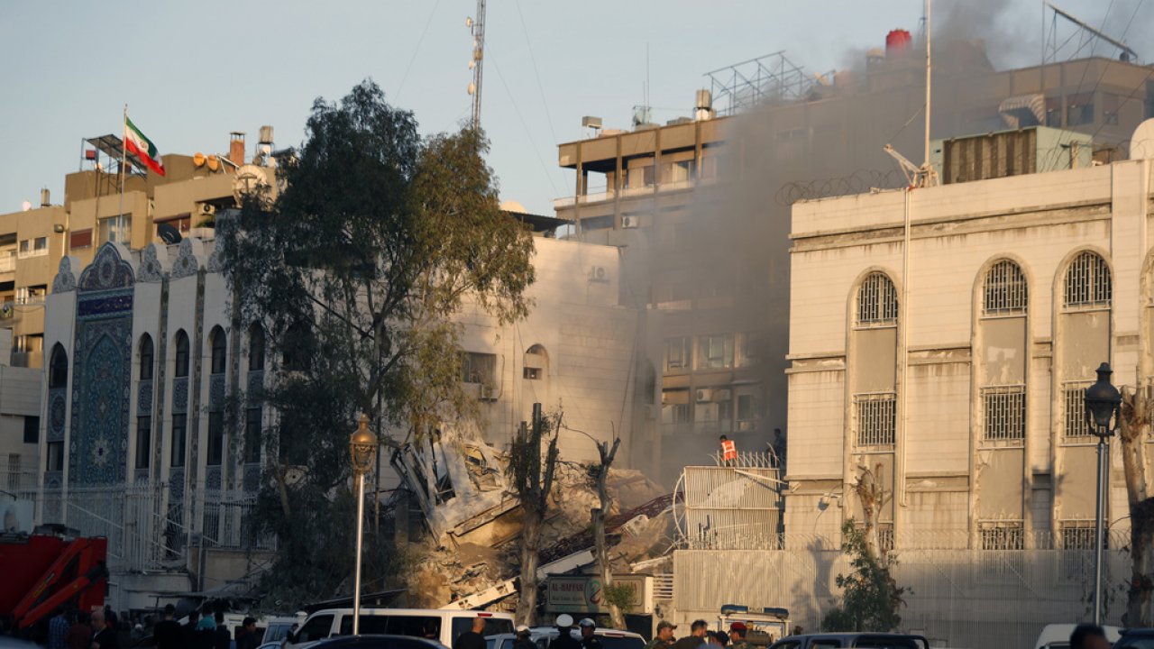 Emergency services work at a destroyed building hit by an air strike in Damascus, Syria.