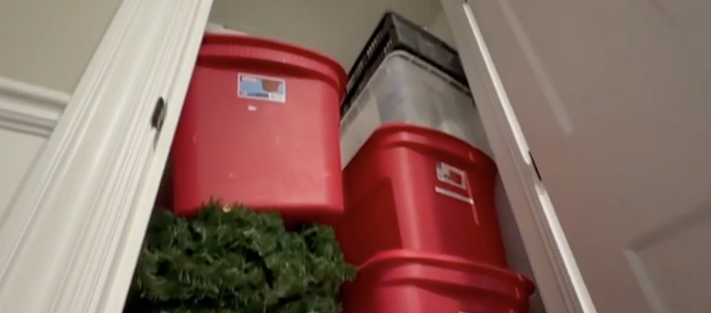 Storage containers stacked in a closet.