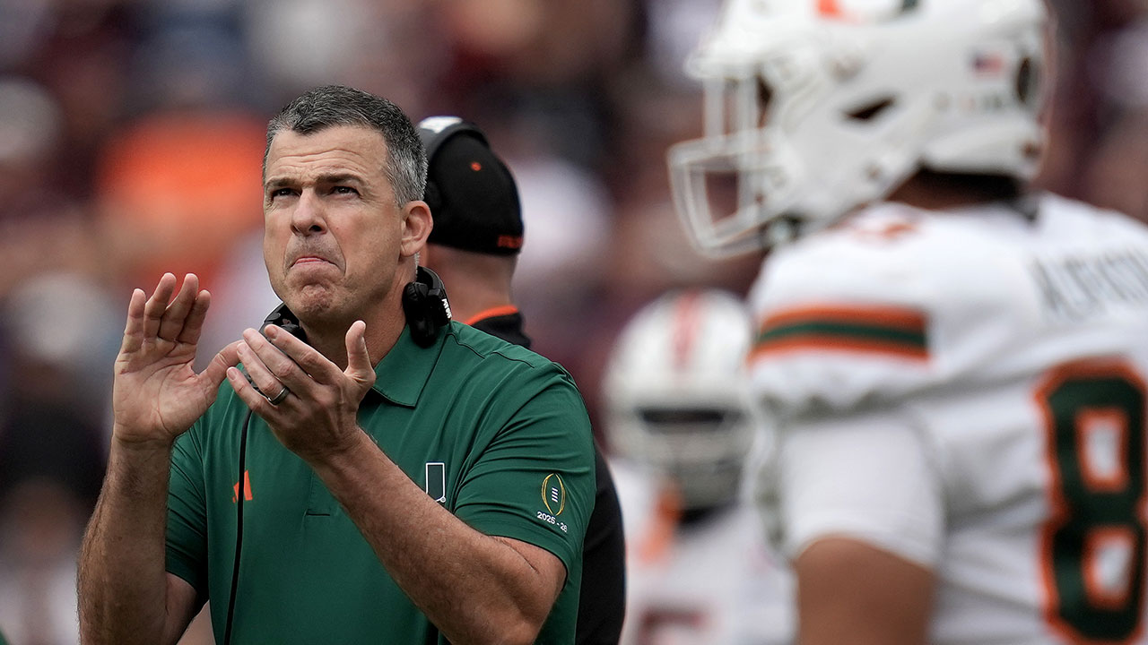 Miami head coach Mario Cristobal claps after his team, leaves the field for a time out against Texas A&M during the first quarter in the first round of the College Football Playoff Saturday, Dec. 20, 2025, in College Station, Texas. (AP Photo/Sam Craft)