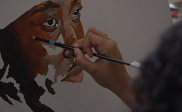 Artist Avry Victor works on a piece from her home studio.