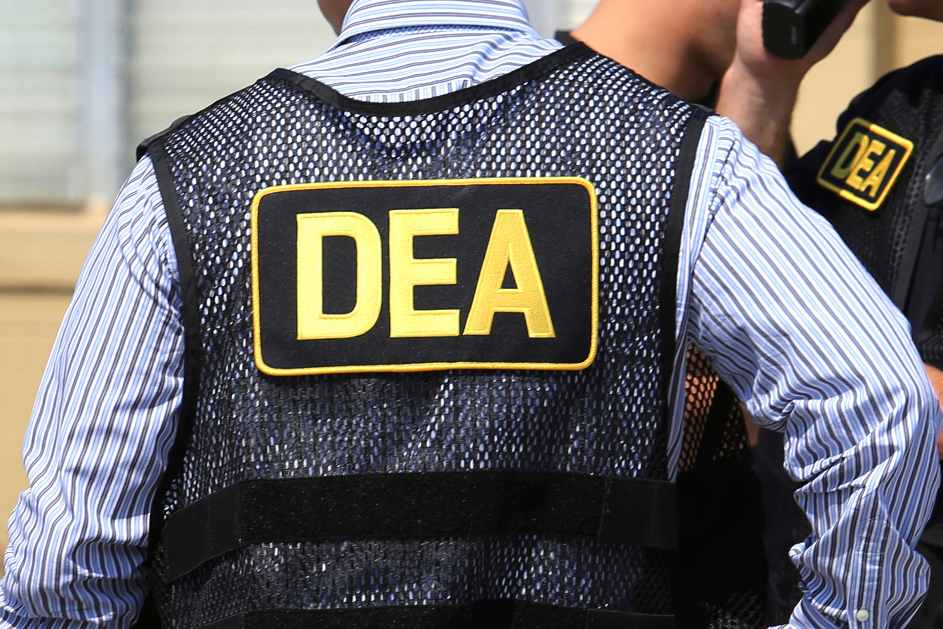 FILE - Lettering marks Drug Enforcement Administration agent's uniforms in Florida,  June 13, 2016. 