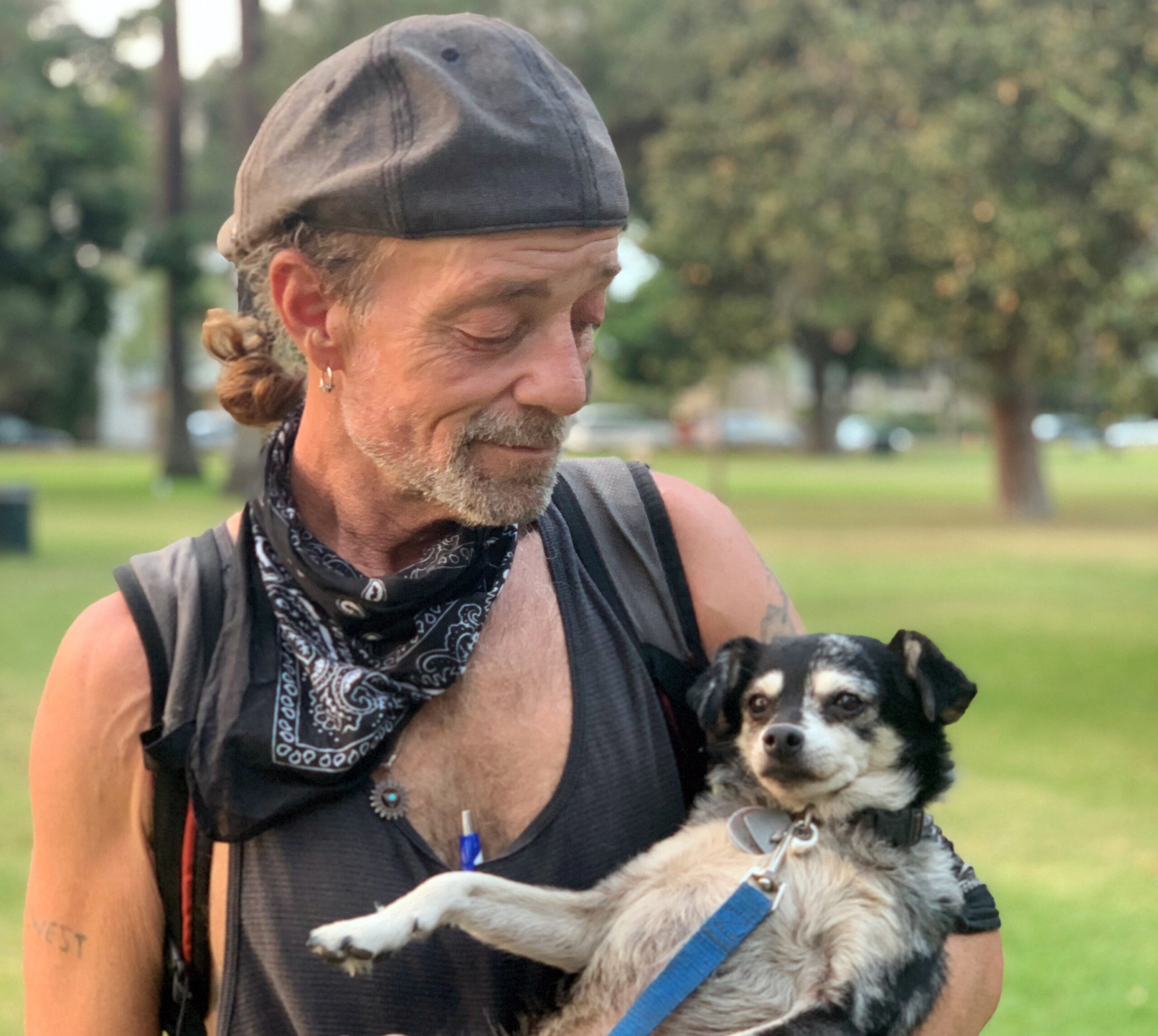 Homeless Man Holding Dog