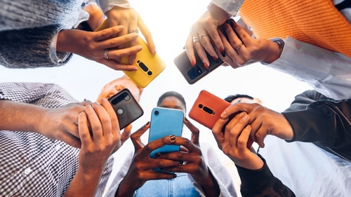 Stock image of teens on smartphones.