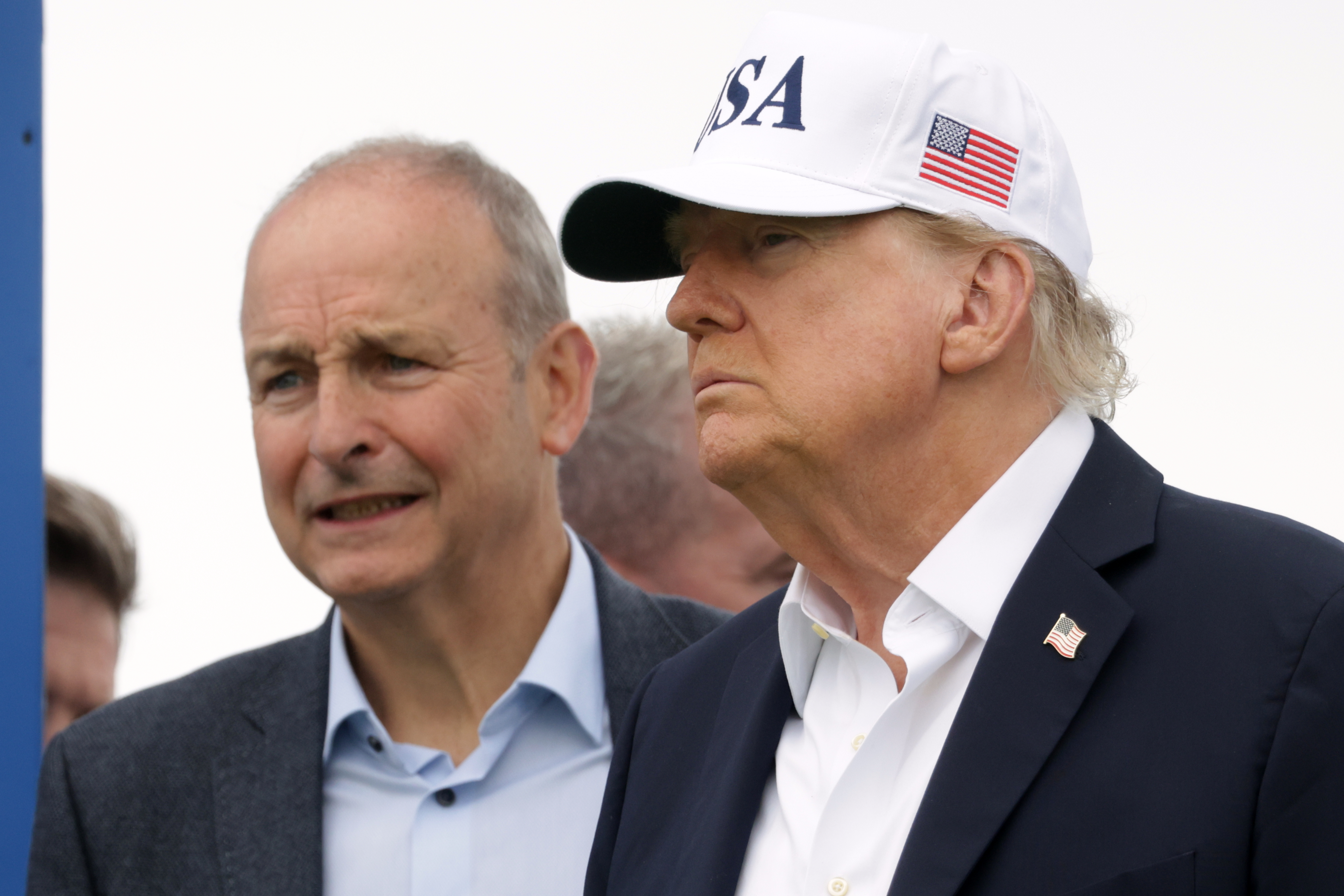 U.S. President Donald Trump and Ireland's Prime Minister Micheal Martin arrive at the first tee during the Irish Open at the Trump International Golf Links course in Doonbeg, Ireland, Sunday, Sept. 13, 2026.