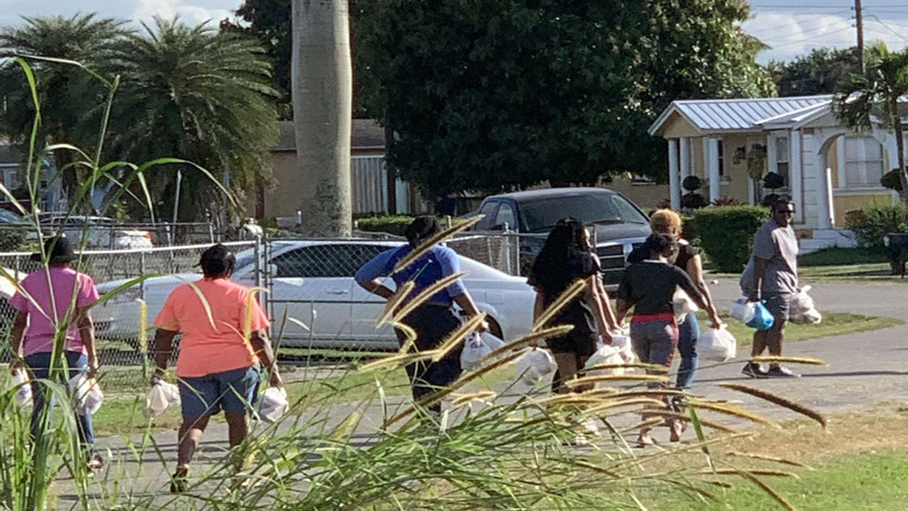 Pastor Kenny Berry and volunteers deliver food to children and seniors