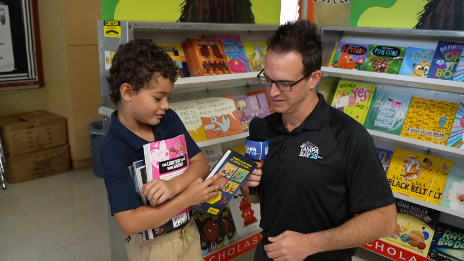 Students at Legacy Preparatory Academy receive free books as part of Give a Child a Book