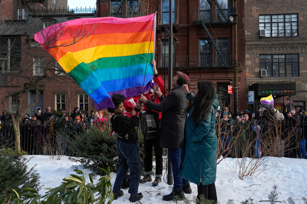New York politicians and activists raise a rainbow flag on a pole in Christopher Park across the street from the Stonewall Inn, Thursday, Feb. 12, 2026, in New York, a few days after it was removed by the National Park Service to comply with guidance from the Trump administration. 