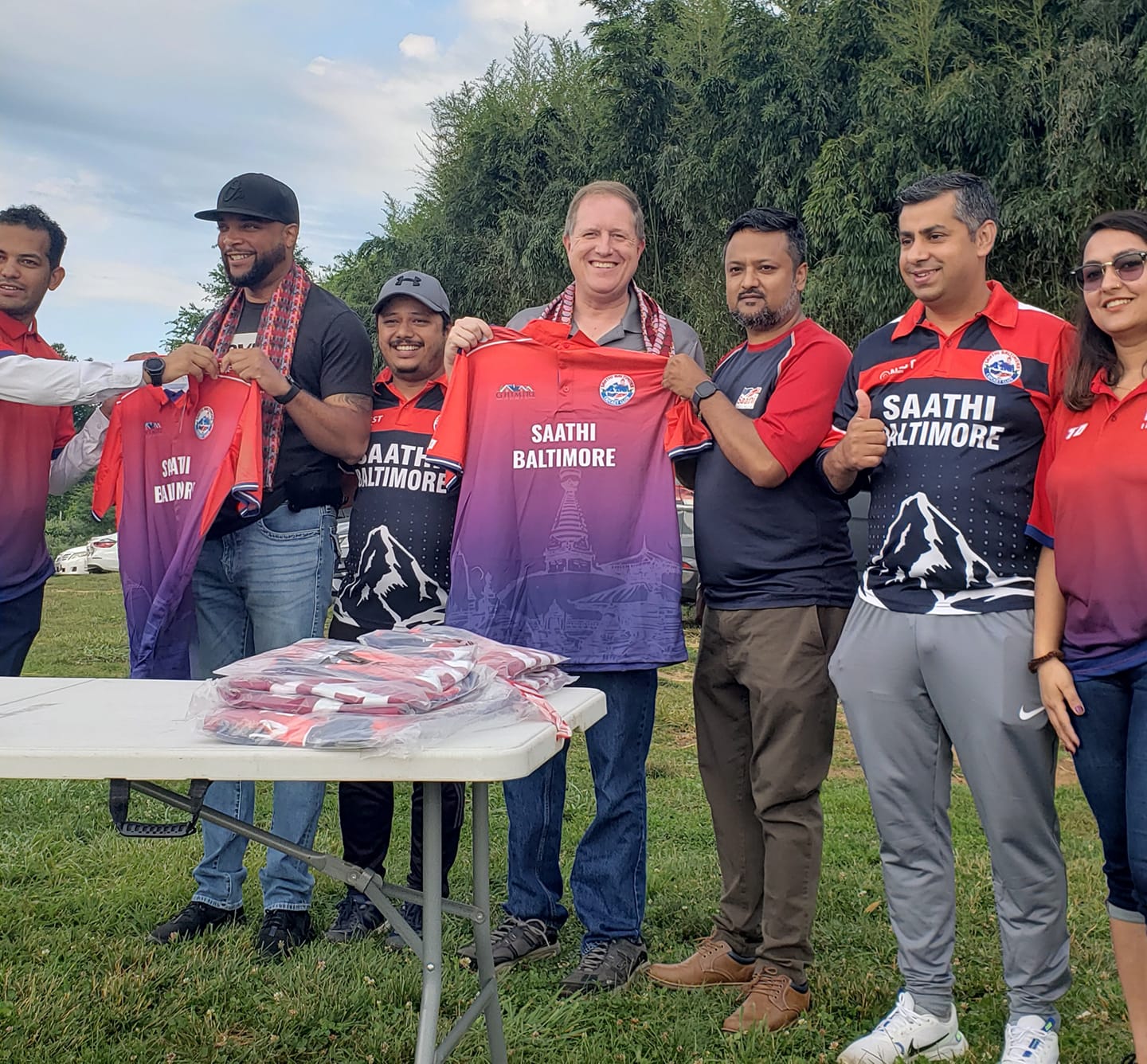 Baltimore County Councilman David Marks gets a T-shirt from the Satthi Baltimore Cricket Club