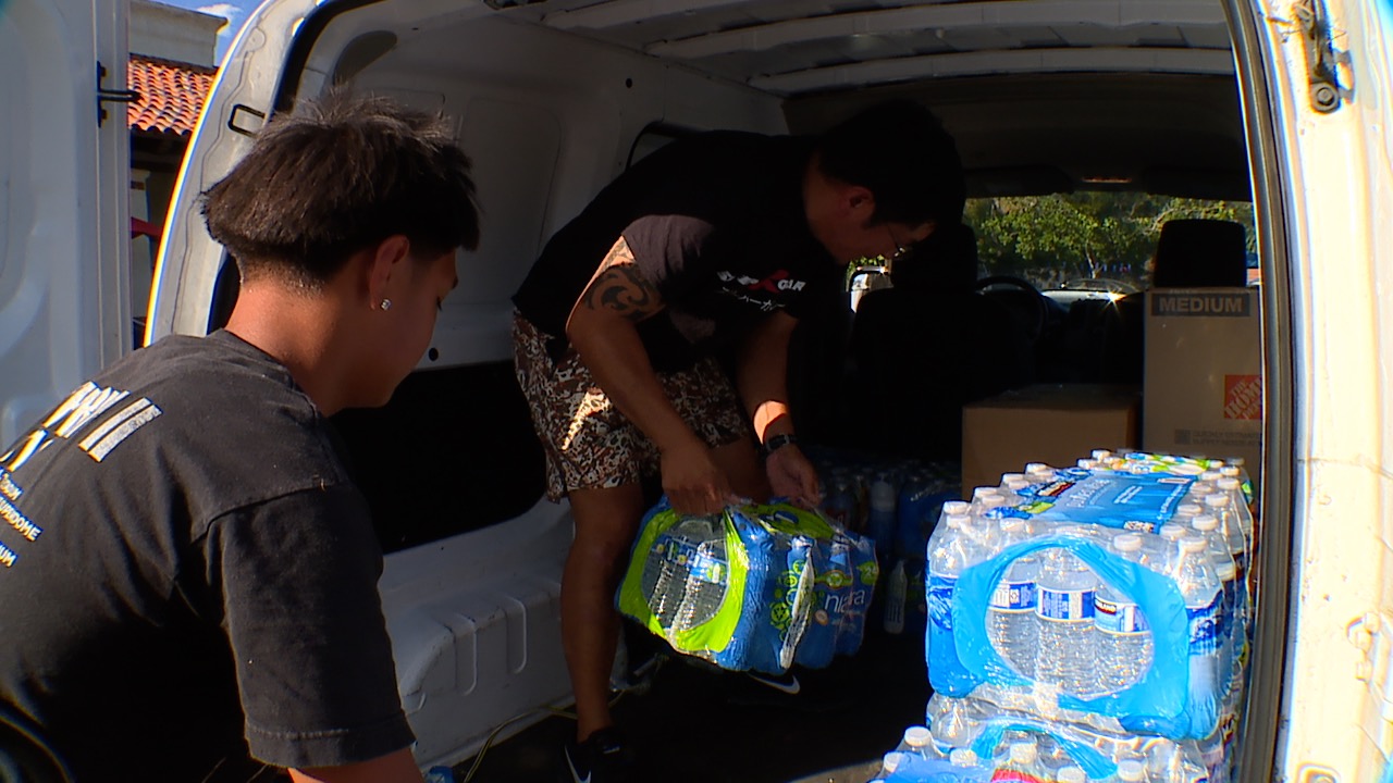 Volunteers work to sort donations for Maui