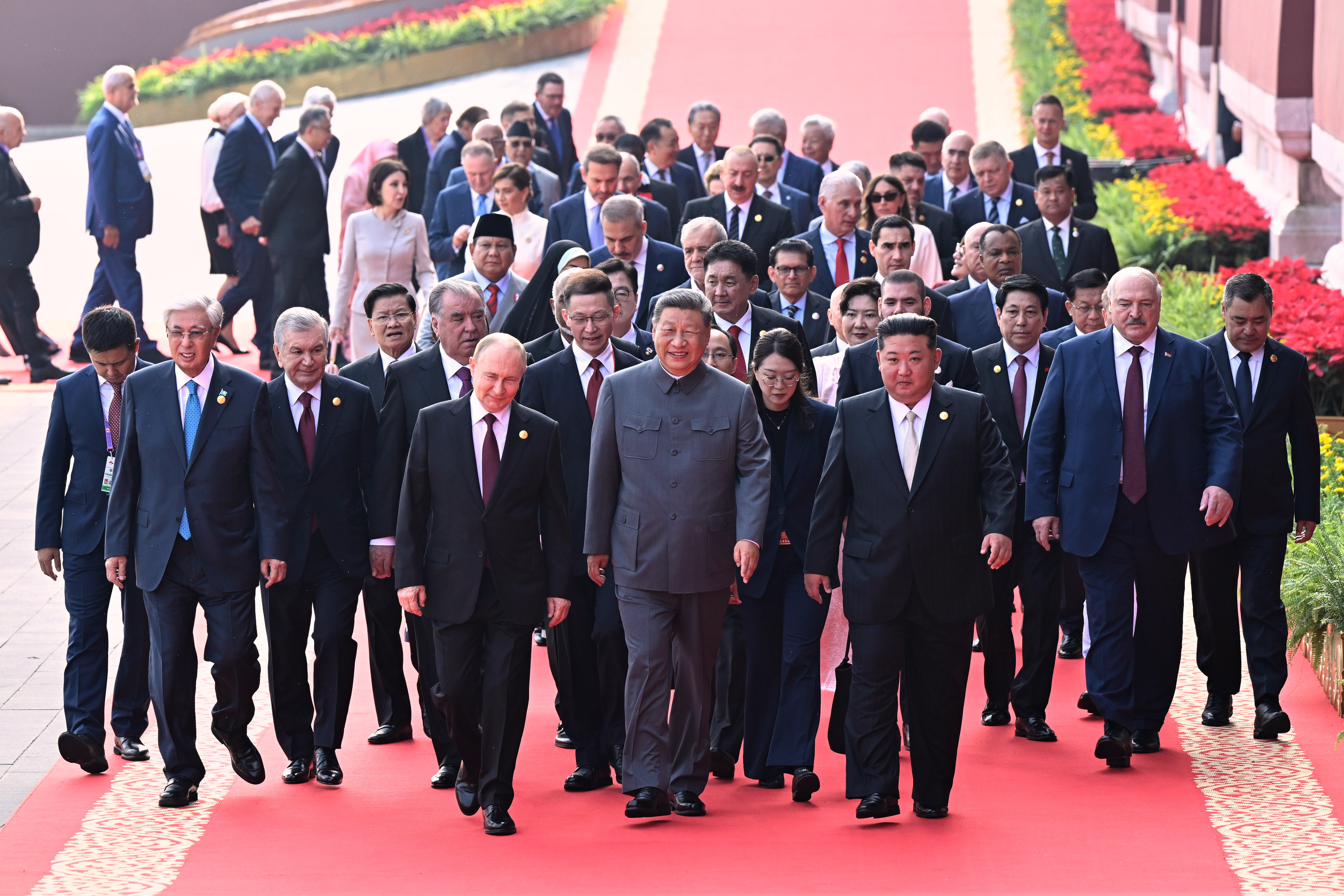 In this photo released by Xinhua News Agency, Chinese President Xi Jinping, center, and foreign leaders including Russia President Vladimir Putin, center left, and North Korean leader Kim Jong Un, center right, walk to Tiananmen Rostrum ahead of a ceremony to commemorate the 80th anniversary of Japan's World War II surrender in Beijing, China, Tuesday, Sept. 3, 2025. 
