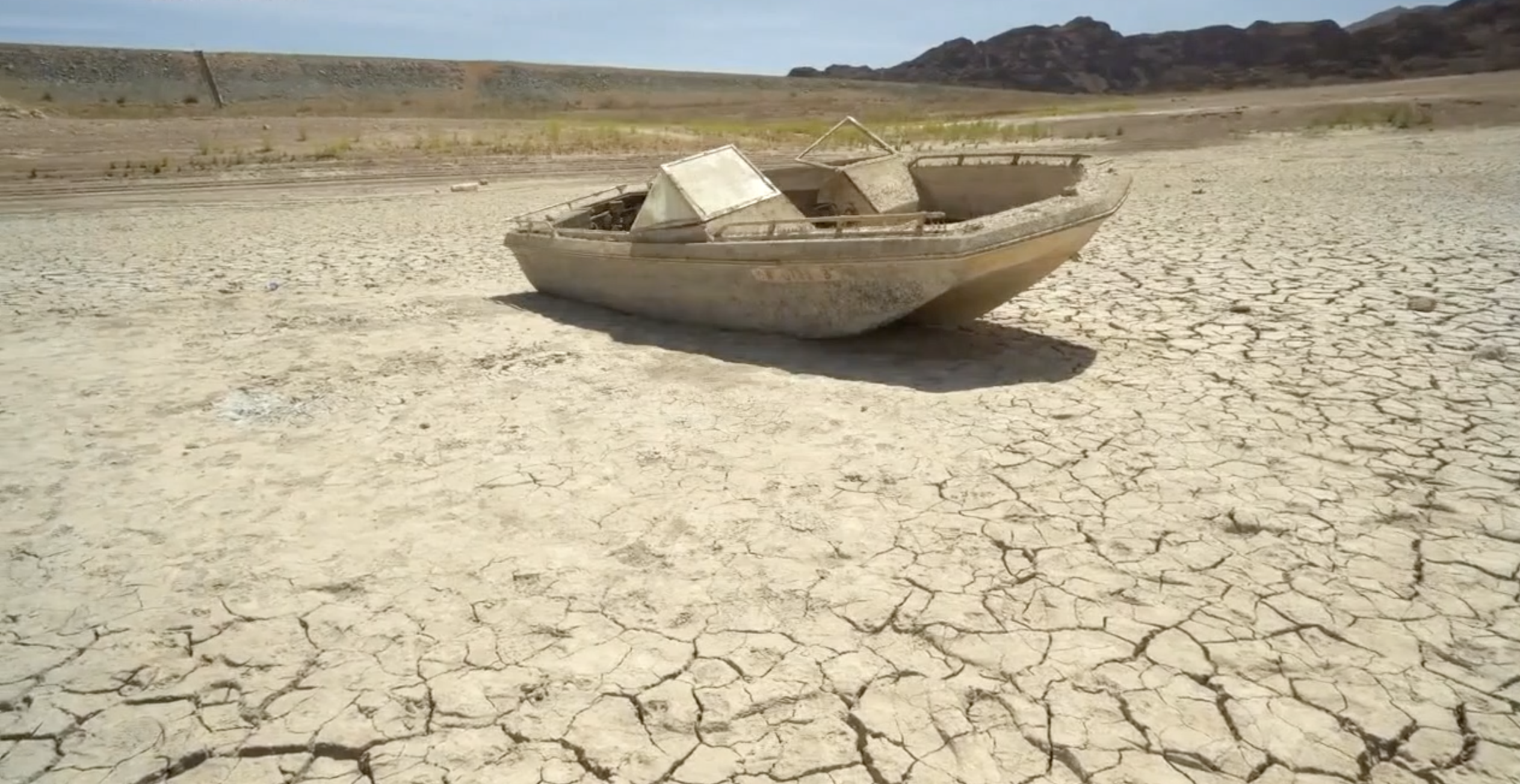 Sunken boat exposed in Lake Mead bed as water levels continue to drop.