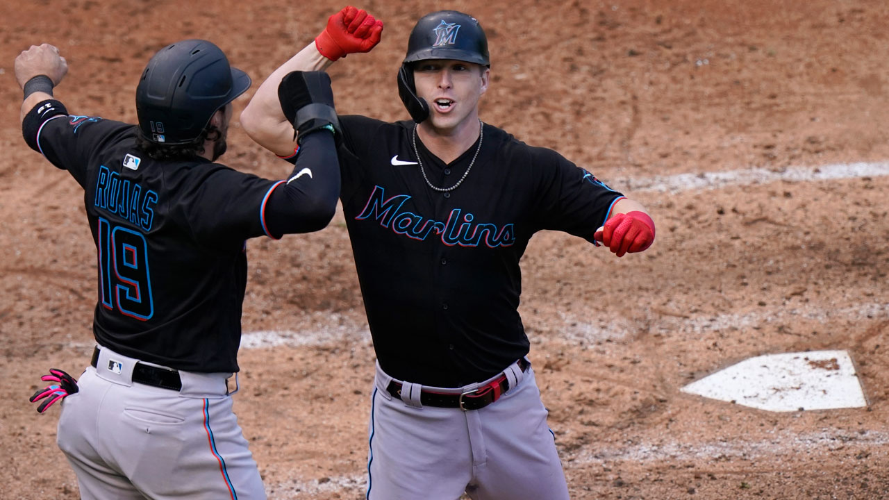 Miguel Rojas celebrates with Corey Dickerson