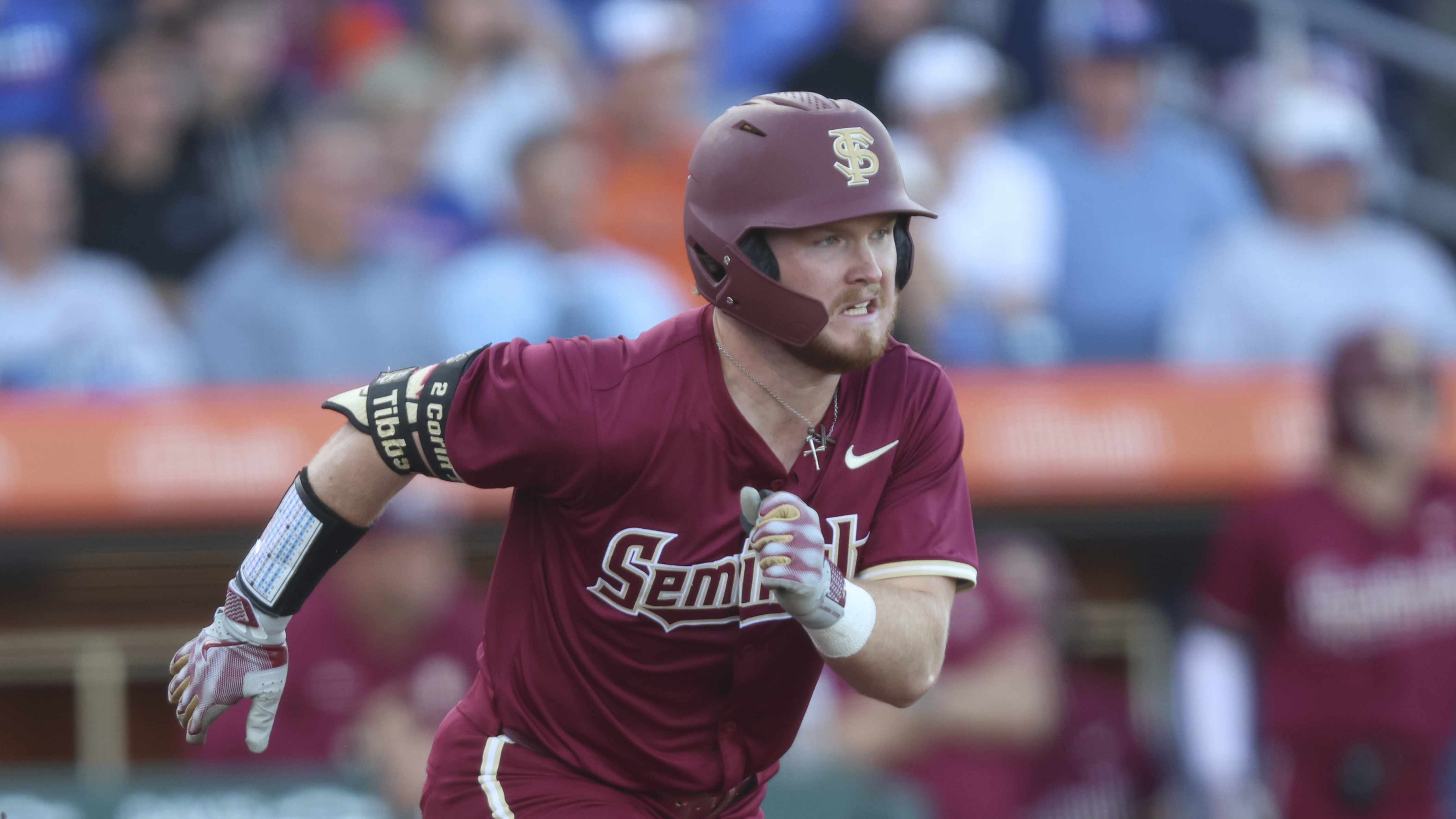 Florida State Seminoles outfielder James Tibbs III runs to first base at Florida Gators, March 12, 2024 