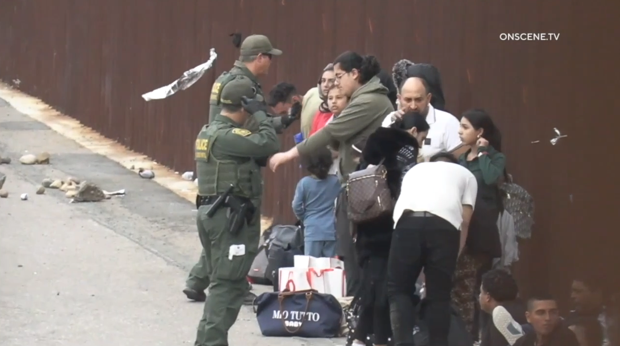 border patrol and migrants at border