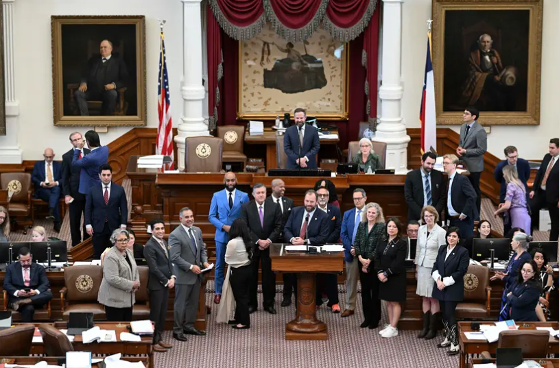 State Rep. John Bucy III, D-Austin, is surrounded by Democrats on the Texas House floor while he advocates for Medicaid expansion during the budget debate in the Texas House on April 10, 2025.