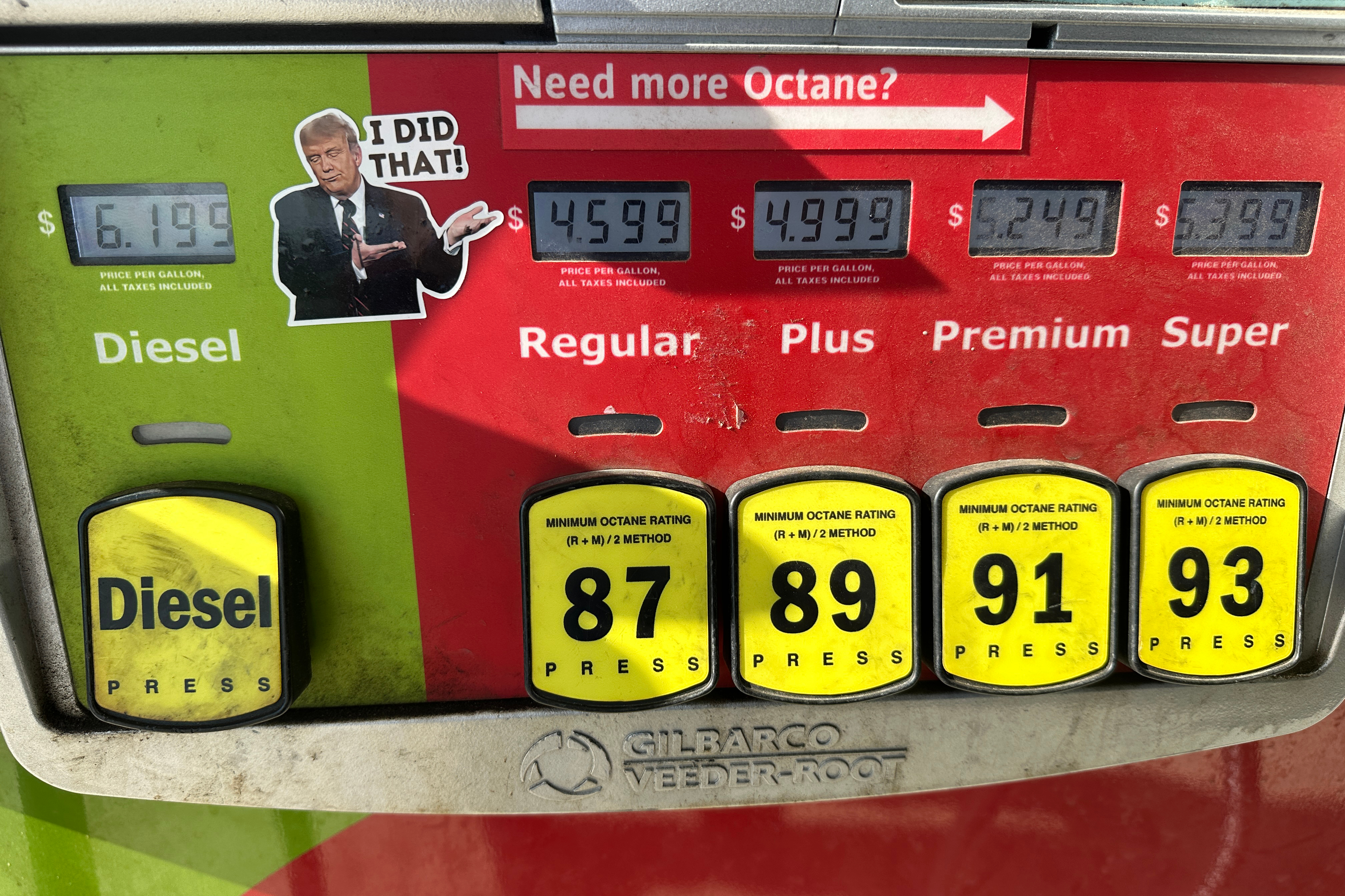 A sticker placed by an unidentified person depicting President Donald Trump and reading "I DID THAT!" is affixed beside gasoline and diesel prices at a gas station in Newtown, Pa., Wednesday, Sept. 9, 2026, as rising pump prices test Trump's campaign pledge to cut energy costs in half.