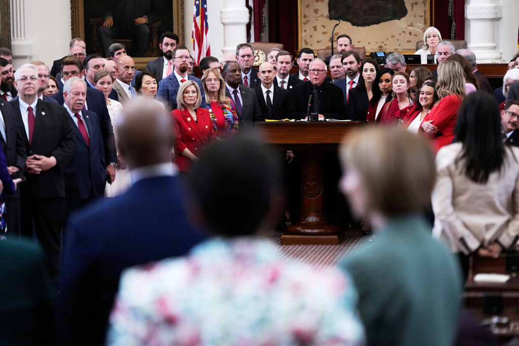 Texas Rep. Todd Hunter, R-Corpus Christi, is surrounded by fellow Republicans as he faces off with Democrats during debate over a redrawn U.S. congressional map in Texas during a special session, Wednesday, Aug. 20, 2025, in Austin, Texas. 