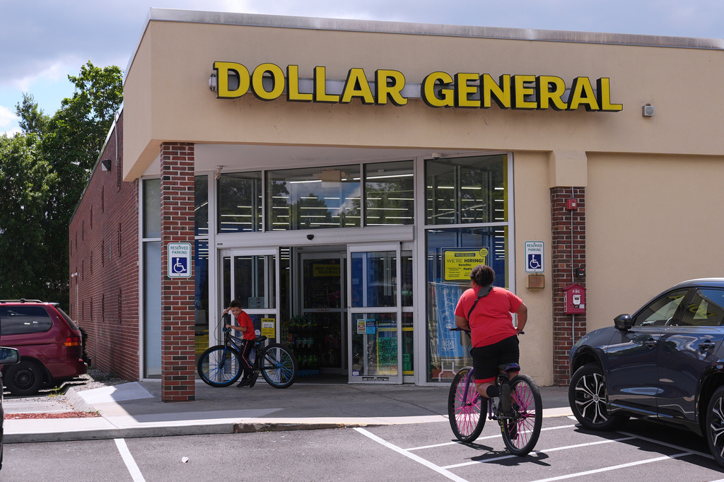 Children ride their bicycles to the Dollar General store, Aug. 21, 2025, in Nashua, N.H. 