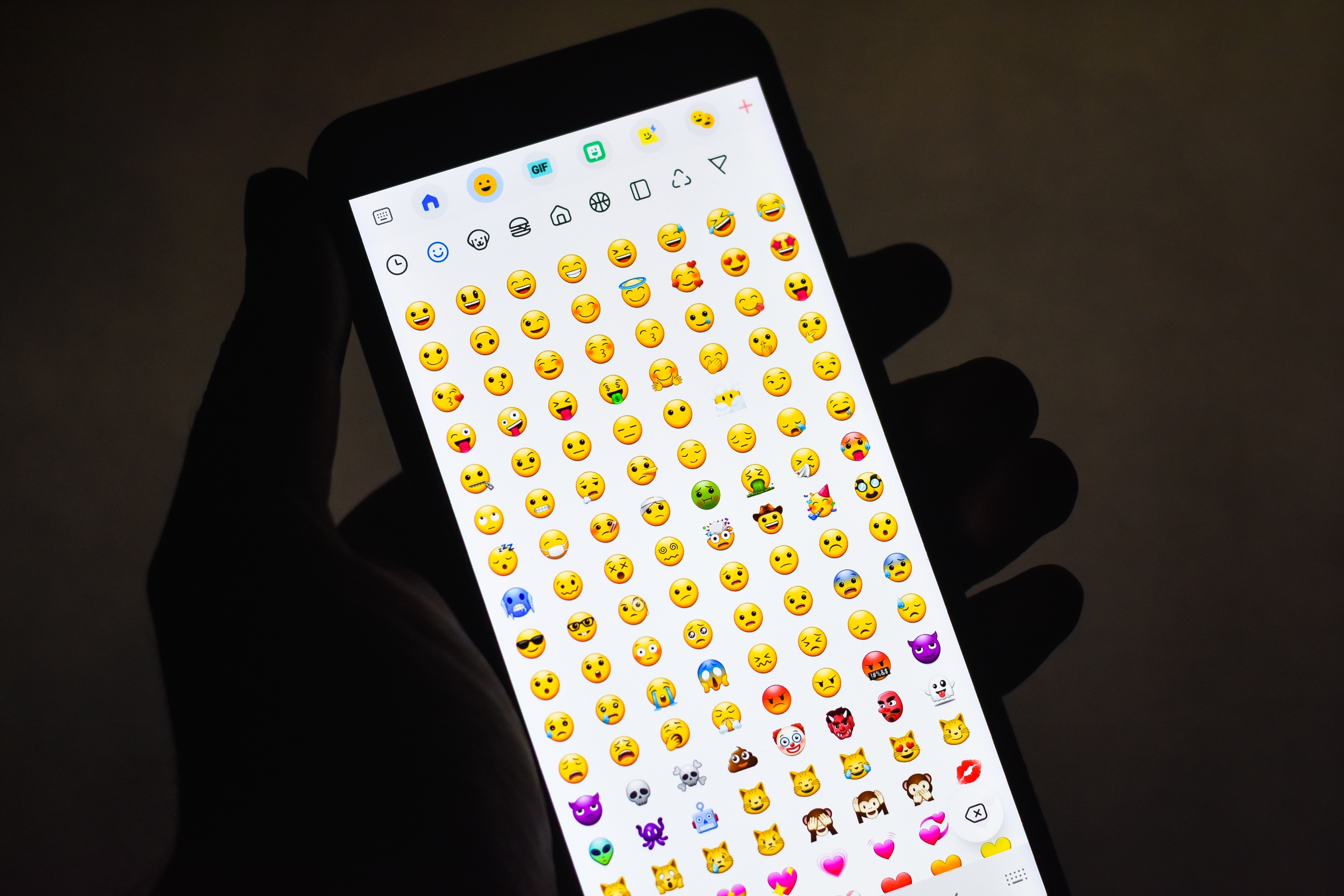Emojis are seen on a person's phone. 