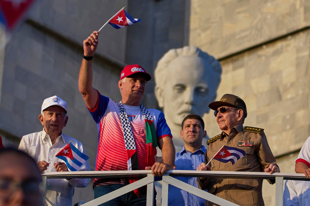 Raul Castro, right, watches the May Day parade accompanied by Cuba's President Miguel Diaz-Canel, second left, and Castro's grandson, Raul Guillermo Rodriguez Castro, center, at Revolution Square in Havana, May 1, 2025. 